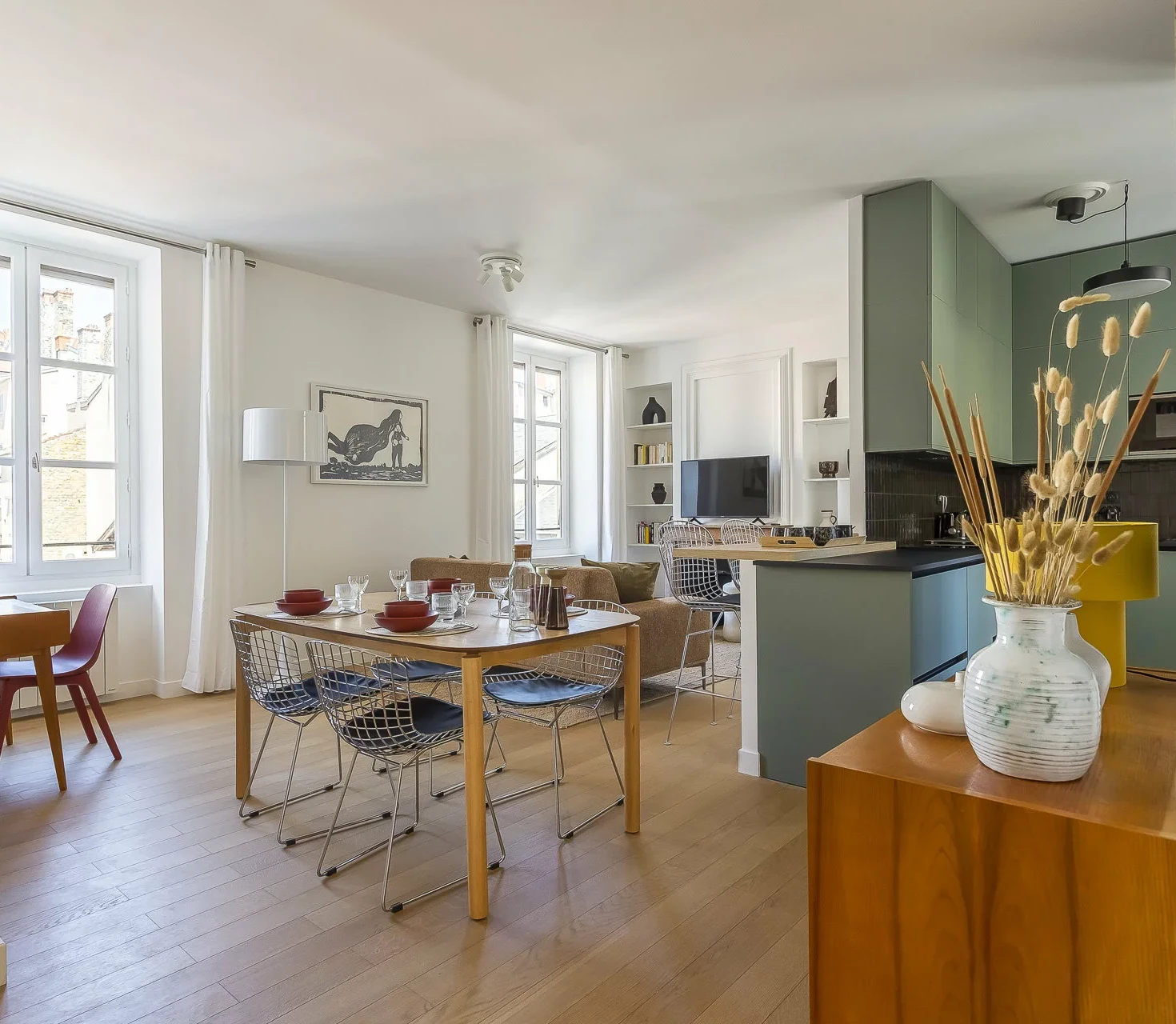 Séjour, salle à manger et cuisine ouverte d'un appartement parisien meublé